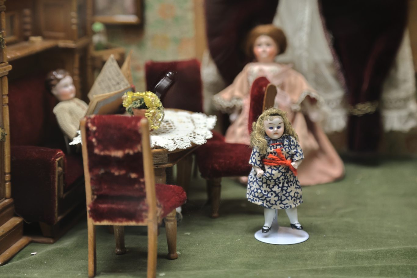 Diorama mit Figuren, einer Tischgruppe und detailreicher Inneneinrichtung.